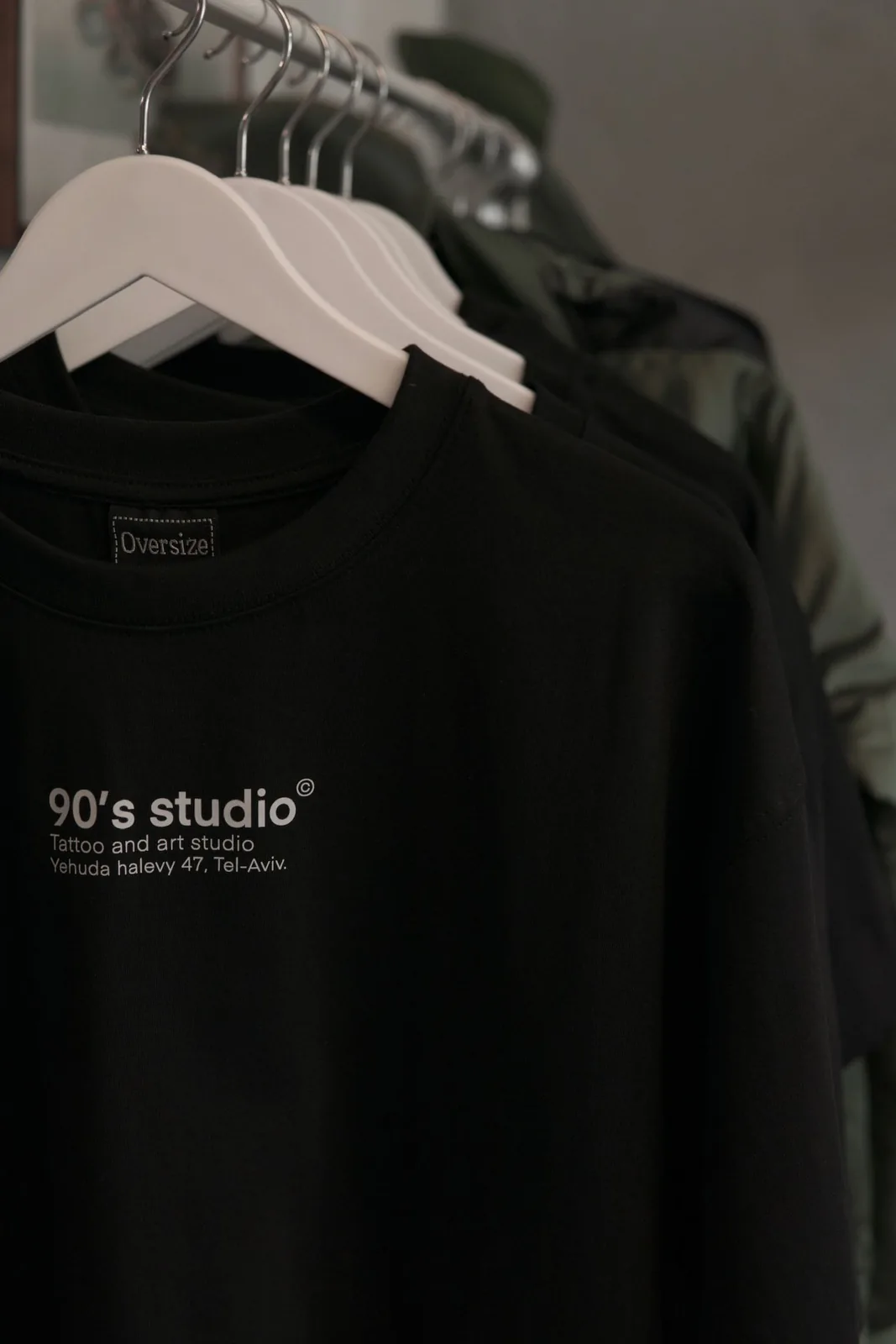 90's studio branded tees hanging in the studio